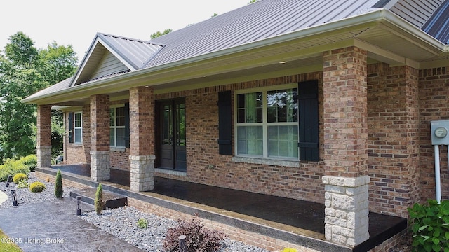 2004 Kepley Rd, Georgetown, IN 47122 - view of side of home with a standing seam roof, brick siding, metal roof, and a porch