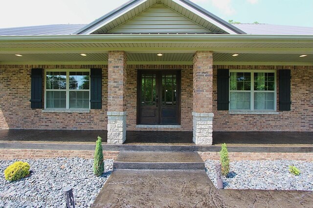 2004 Kepley Rd, Georgetown, IN 47122 - view of exterior entry featuring a porch, brick siding, and french doors