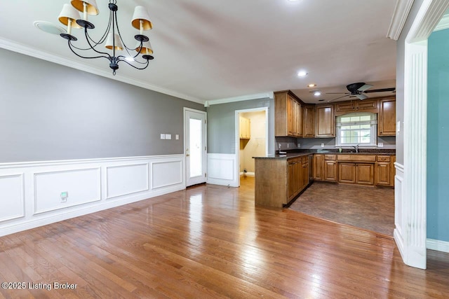 766 Pottershop Rd, Bardstown, KY 40004 - kitchen with dark countertops, dark wood-style floors, brown cabinets, a chandelier, and crown molding