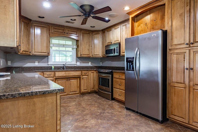 766 Pottershop Rd, Bardstown, KY 40004 - kitchen with stainless steel appliances, ceiling fan, dark stone counters, brown cabinetry, and recessed lighting