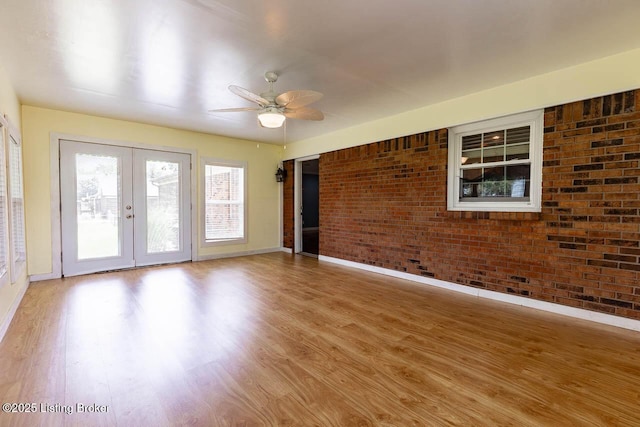 766 Pottershop Rd, Bardstown, KY 40004 - spare room featuring brick wall, french doors, wood finished floors, and a ceiling fan