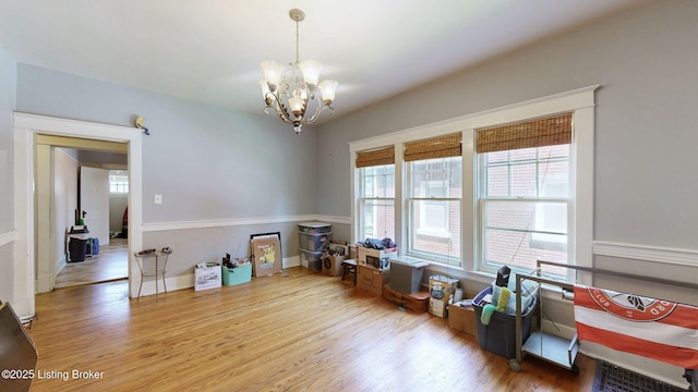 1344 S Brook St, Louisville, KY 40208 - rec room featuring wood finished floors, a chandelier, and baseboards