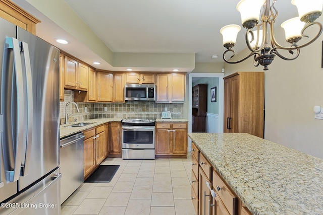 1007 Girard Dr, Louisville, KY 40222 - kitchen featuring appliances with stainless steel finishes, a sink, light tile patterned floors, tasteful backsplash, and light stone countertops