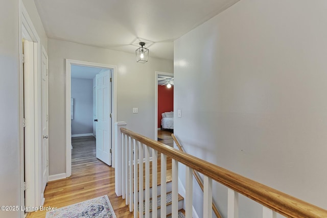 1007 Girard Dr, Louisville, KY 40222 - corridor featuring an upstairs landing, light wood-style flooring, and baseboards