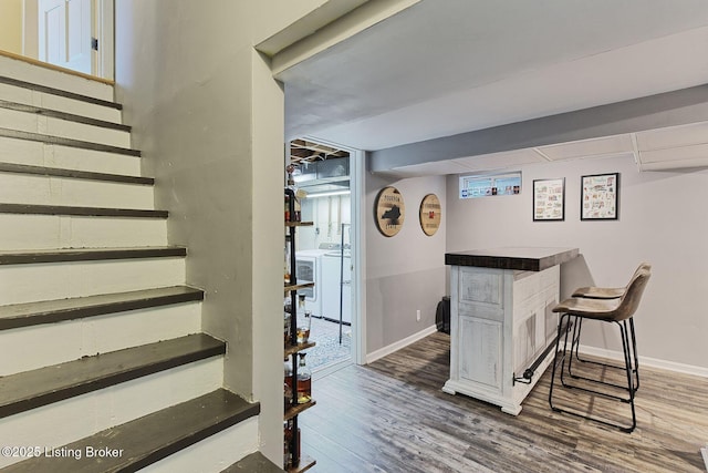1007 Girard Dr, Louisville, KY 40222 - indoor dry bar with stairs, wood finished floors, baseboards, and washer / clothes dryer