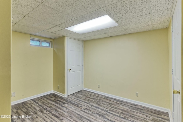 1007 Girard Dr, Louisville, KY 40222 - below grade area with wood finished floors, a paneled ceiling, and baseboards