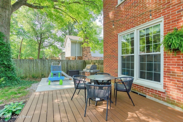 1007 Girard Dr, Louisville, KY 40222 - wooden terrace featuring a fenced backyard, outdoor dining area, and area for grilling