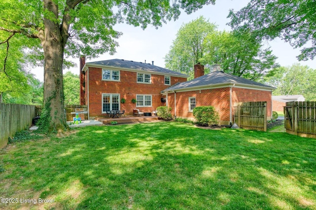 1007 Girard Dr, Louisville, KY 40222 - back of property with a chimney, brick siding, and a patio area