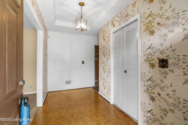 7509 Appletree Way, Louisville, KY 40228 - corridor featuring wallpapered walls, light floors, a chandelier, and a tray ceiling