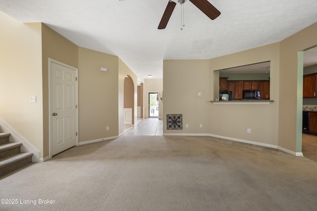 8811 Eli Dr, Louisville, KY 40291 - unfurnished living room featuring light colored carpet, ceiling fan, arched walkways, baseboards, and a textured ceiling