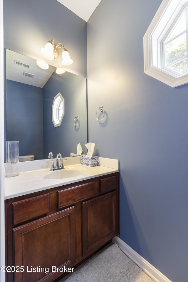 8811 Eli Dr, Louisville, KY 40291 - bathroom with vanity, plenty of natural light, and baseboards