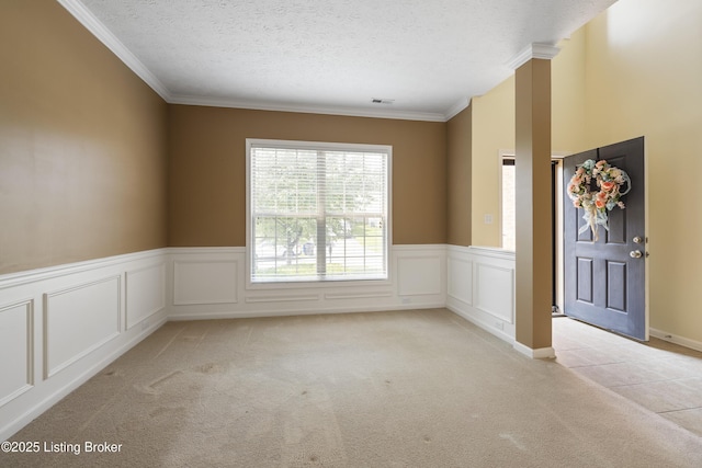 8811 Eli Dr, Louisville, KY 40291 - spare room featuring light colored carpet, ornamental molding, a textured ceiling, and wainscoting