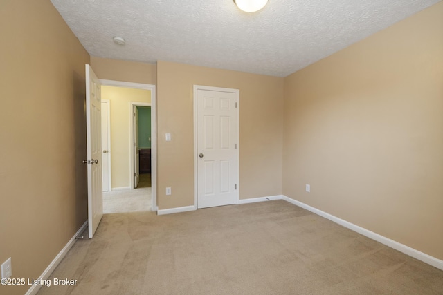 8811 Eli Dr, Louisville, KY 40291 - unfurnished bedroom with light colored carpet, a textured ceiling, and baseboards