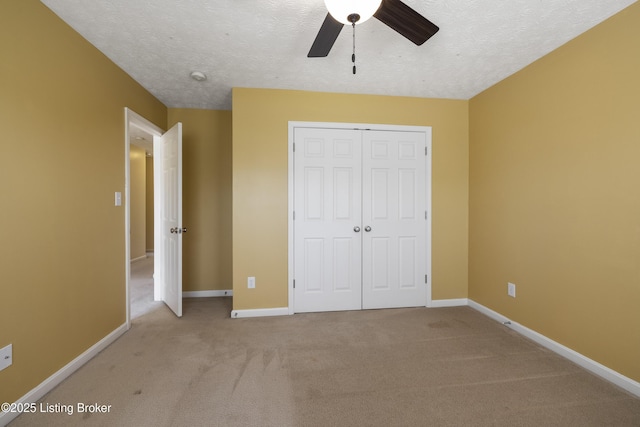 8811 Eli Dr, Louisville, KY 40291 - unfurnished bedroom with light carpet, a closet, baseboards, a textured ceiling, and a ceiling fan