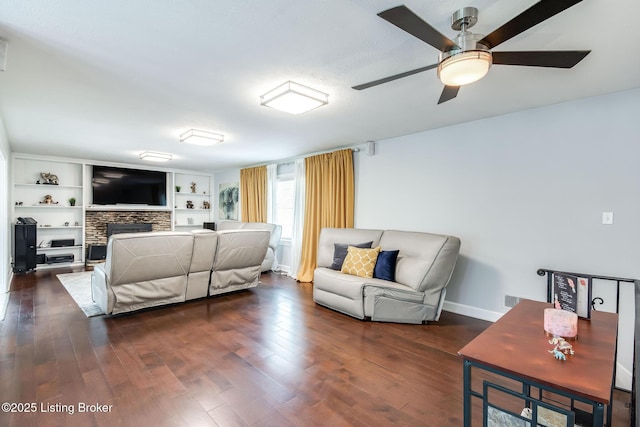 2508 Windsor Forest Dr, Louisville, KY 40272 - living room with a ceiling fan, a stone fireplace, dark wood finished floors, and baseboards