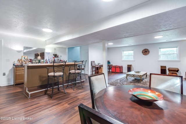 2508 Windsor Forest Dr, Louisville, KY 40272 - dining space featuring a bar, dark wood-style flooring, and a textured ceiling