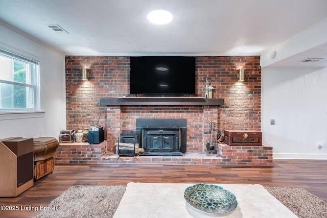 2508 Windsor Forest Dr, Louisville, KY 40272 - living room featuring wood finished floors, a wood stove, crown molding, and baseboards