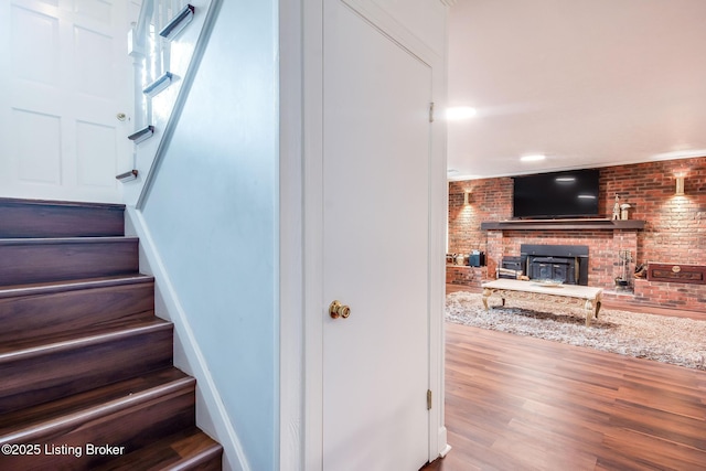 2508 Windsor Forest Dr, Louisville, KY 40272 - staircase featuring brick wall, a brick fireplace, and wood finished floors
