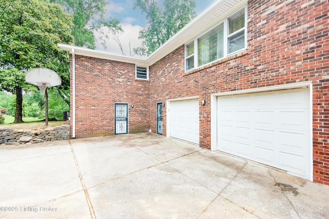 2508 Windsor Forest Dr, Louisville, KY 40272 - view of side of property with concrete driveway, an attached garage, and brick siding