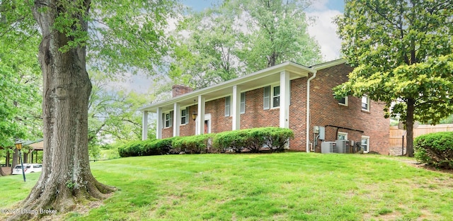 2508 Windsor Forest Dr, Louisville, KY 40272 - raised ranch featuring a chimney, brick siding, and cooling unit
