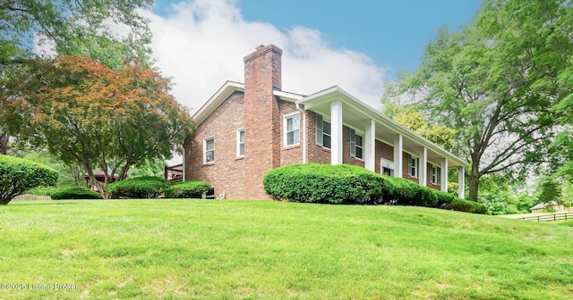 2508 Windsor Forest Dr, Louisville, KY 40272 - view of side of home featuring a chimney, a lawn, and brick siding