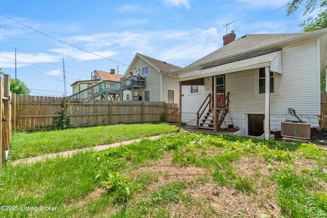 4015 S 5th St, Louisville, KY 40214 - back of house featuring a chimney, cooling unit, and a shingled roof