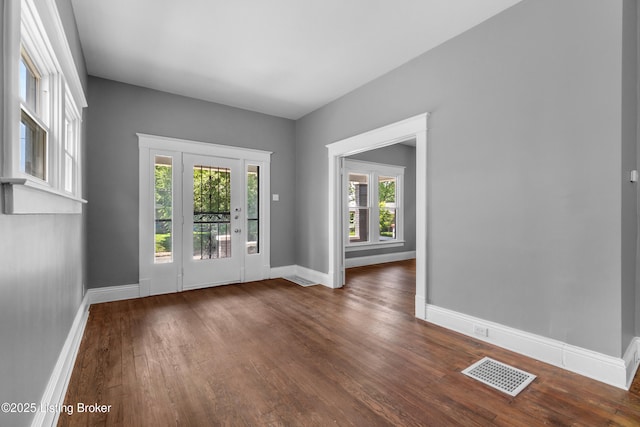 4015 S 5th St, Louisville, KY 40214 - doorway to outside featuring dark wood finished floors and baseboards