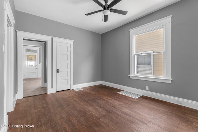 4015 S 5th St, Louisville, KY 40214 - spare room featuring dark wood-type flooring, baseboards, and ceiling fan
