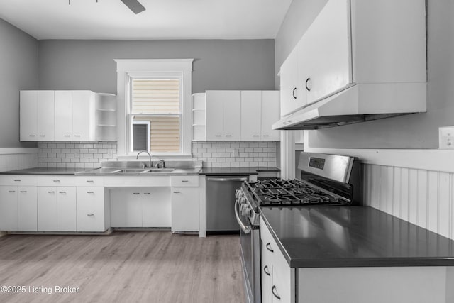 4015 S 5th St, Louisville, KY 40214 - kitchen with open shelves, appliances with stainless steel finishes, stainless steel countertops, white cabinets, and light wood-style flooring