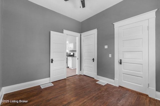 4015 S 5th St, Louisville, KY 40214 - unfurnished bedroom with dark wood-type flooring, baseboards, ceiling fan, and a closet