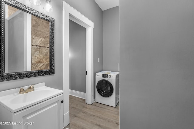 4015 S 5th St, Louisville, KY 40214 - laundry room featuring washer / clothes dryer, light wood-style flooring, a sink, and baseboards