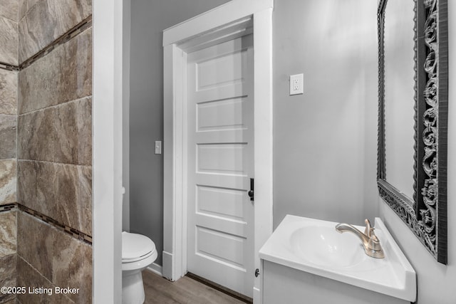 4015 S 5th St, Louisville, KY 40214 - bathroom featuring toilet, vanity, and wood finished floors