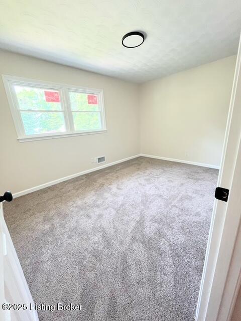 7402 Nottoway Cir, Louisville, KY 40214 - spare room featuring carpet floors and baseboards