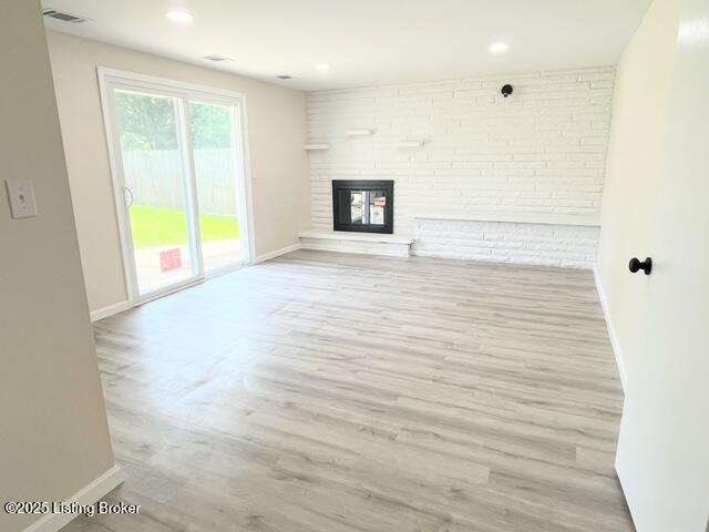 7402 Nottoway Cir, Louisville, KY 40214 - unfurnished living room with wood finished floors, a fireplace, and recessed lighting