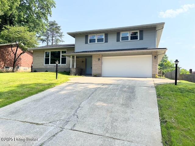 7402 Nottoway Cir, Louisville, KY 40214 - split level home featuring an attached garage, concrete driveway, and brick siding