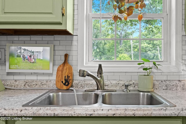 9712 Keys Ferry Rd, Fairdale, KY 40118 - kitchen view of a sink, green cabinets, light countertops, and decorative backsplash