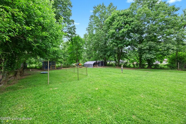 9712 Keys Ferry Rd, Fairdale, KY 40118 - view of green lawn featuring exterior structure, an outbuilding, and view of scattered trees