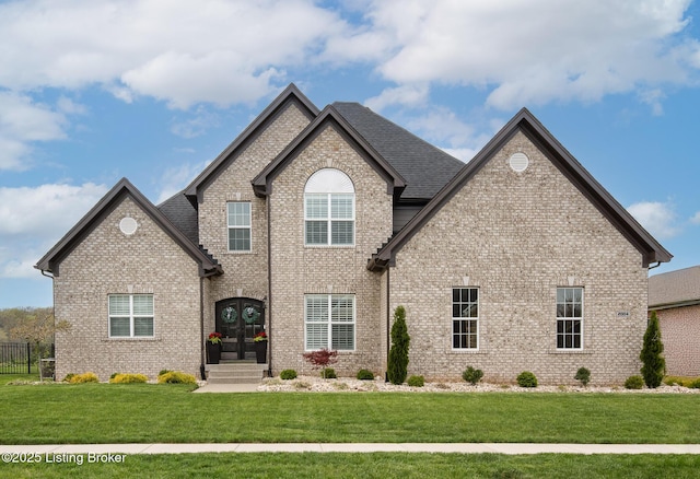 2004 Scenic Lakes Dr, Louisville, KY 40245 - view of front facade with brick siding, a front yard, and french doors
