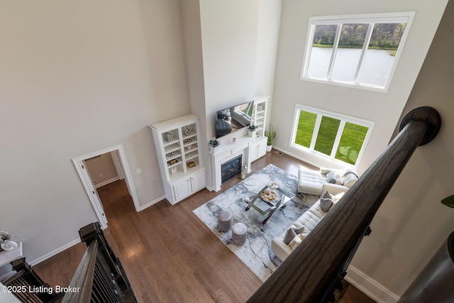 2004 Scenic Lakes Dr, Louisville, KY 40245 - living area featuring a fireplace with flush hearth, a high ceiling, dark wood finished floors, and baseboards