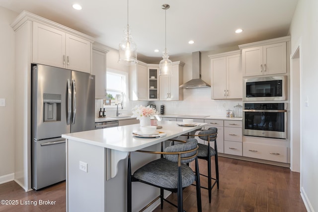 2004 Scenic Lakes Dr, Louisville, KY 40245 - kitchen featuring appliances with stainless steel finishes, wall chimney exhaust hood, a sink, tasteful backsplash, and a kitchen island
