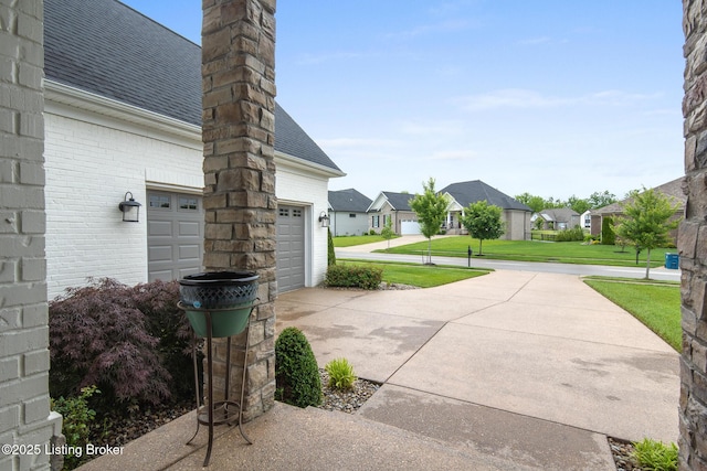 14829 Ava Brook Cir, Louisville, KY 40245 - view of patio featuring a residential view, a garage, and concrete driveway
