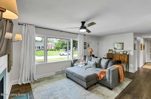 4523 Blenheim Rd, Louisville, KY 40207 - living room with dark wood finished floors, a ceiling fan, baseboards, and a fireplace