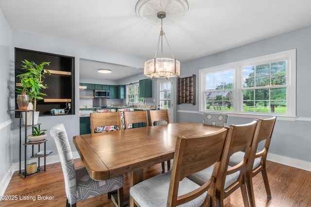 7007 Graymoor Rd, Louisville, KY 40222 - dining area with a chandelier, light wood-type flooring, and baseboards