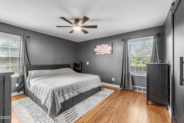 7007 Graymoor Rd, Louisville, KY 40222 - bedroom with wood finished floors, multiple windows, baseboards, and a ceiling fan