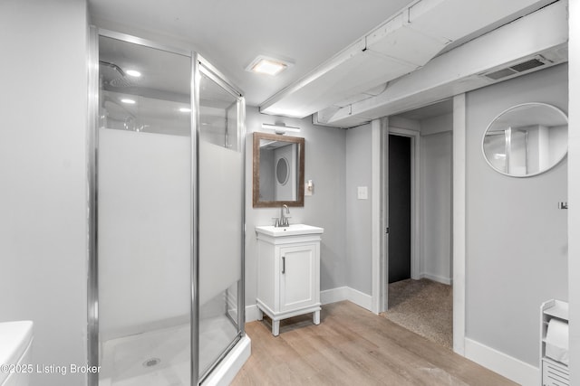 7007 Graymoor Rd, Louisville, KY 40222 - bathroom featuring a stall shower, vanity, wood finished floors, and baseboards