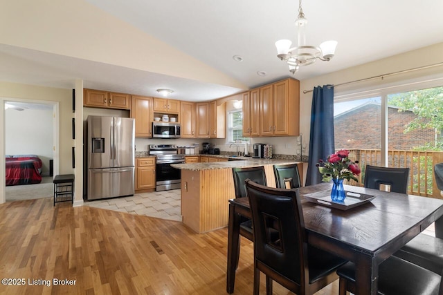 1421 W Elm Rd, Radcliff, KY 40160 - kitchen featuring stainless steel appliances, a chandelier, a peninsula, lofted ceiling, and light wood-type flooring