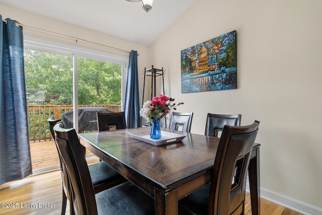 1421 W Elm Rd, Radcliff, KY 40160 - dining space featuring light wood finished floors, vaulted ceiling, and baseboards