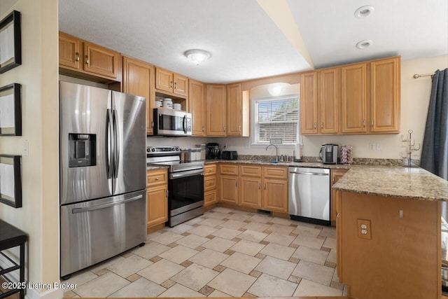 1421 W Elm Rd, Radcliff, KY 40160 - kitchen featuring appliances with stainless steel finishes, a peninsula, a sink, light stone counters, and recessed lighting
