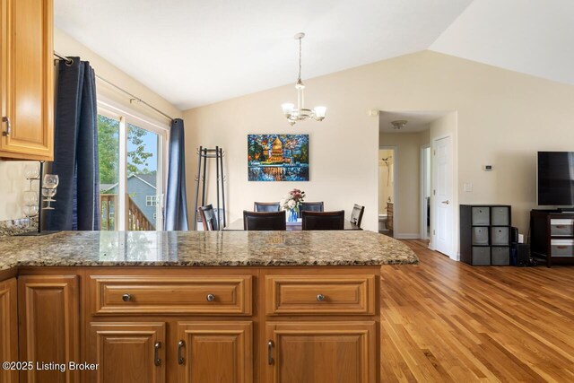 1421 W Elm Rd, Radcliff, KY 40160 - kitchen featuring lofted ceiling, a chandelier, light wood finished floors, a peninsula, and decorative light fixtures