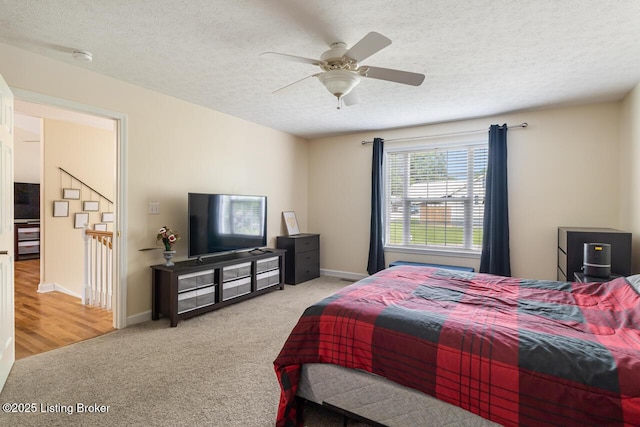 1421 W Elm Rd, Radcliff, KY 40160 - carpeted bedroom with a textured ceiling, baseboards, and a ceiling fan